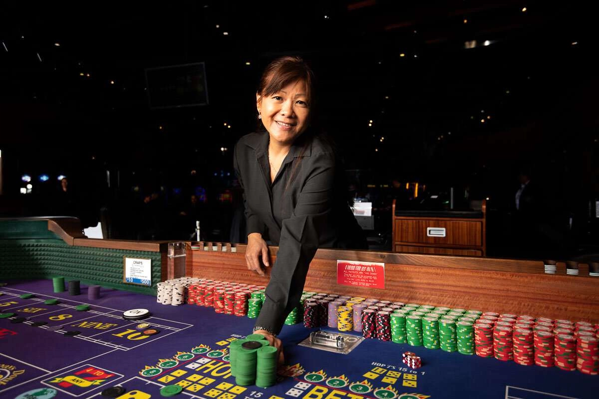 Dealer passes winning chips ©robert lowdon