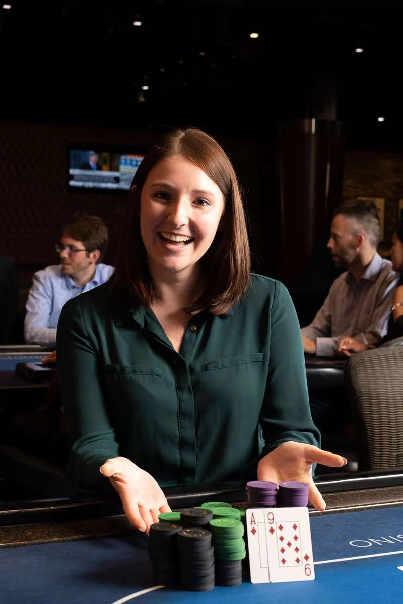 Player poses with winning poker hand. © robert lowdon