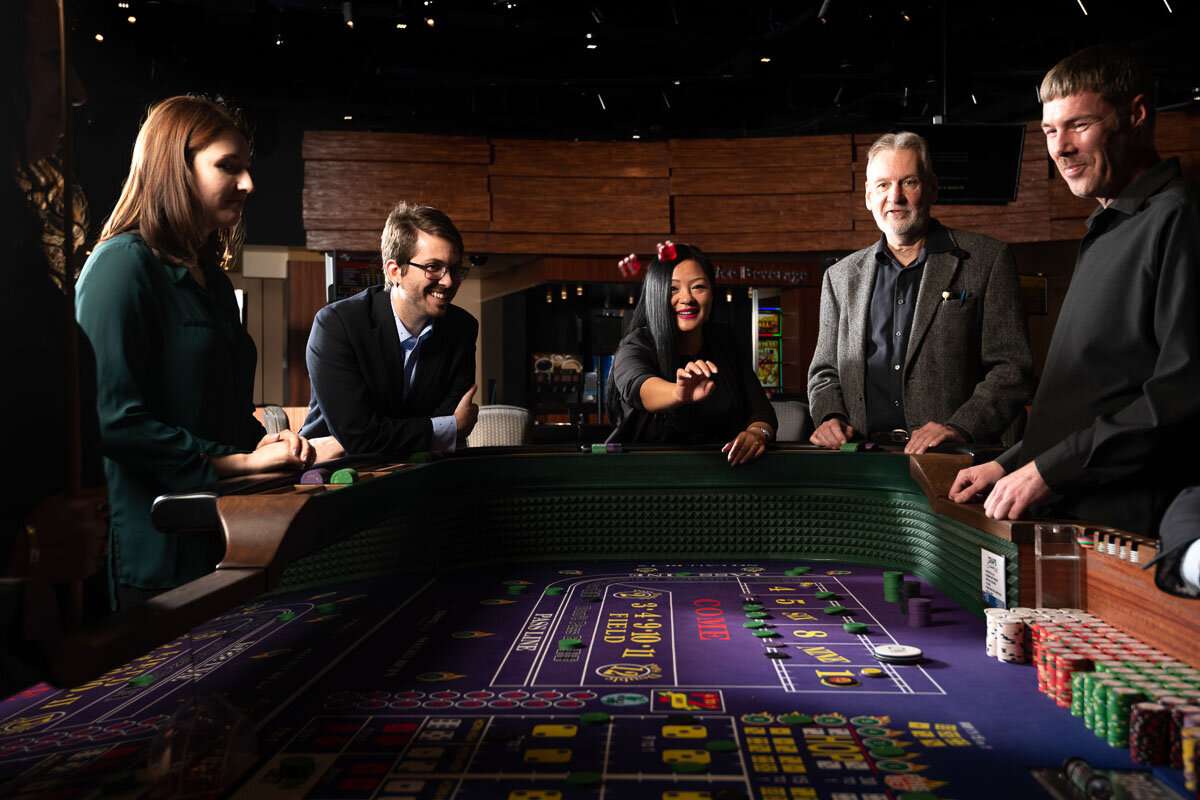 Player rolls dice in craps game ©robert lowdon