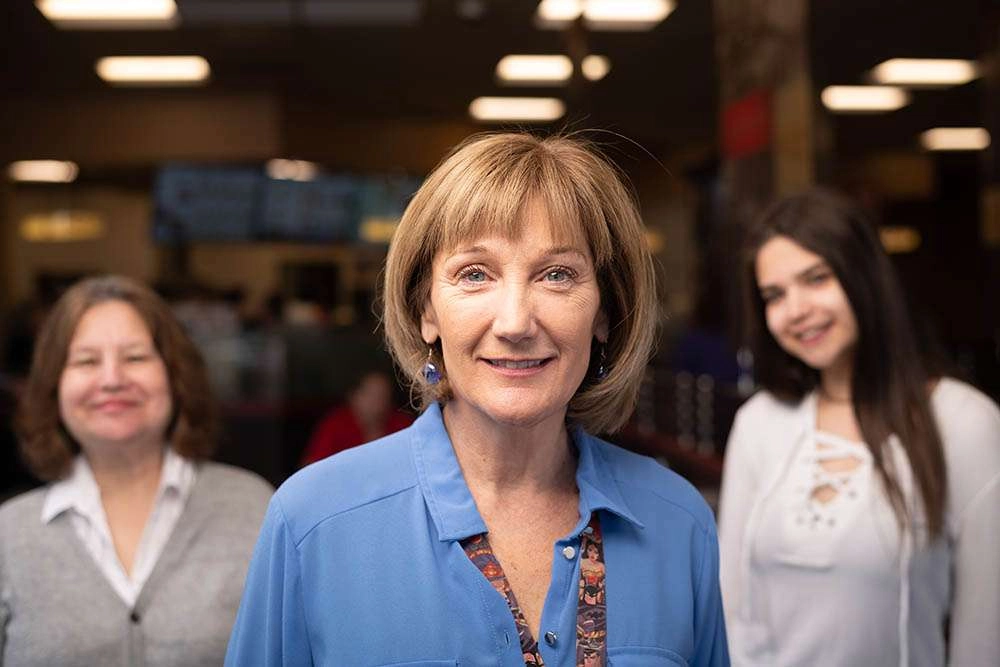 A counselor with her two clients in the background. © robert lowdon