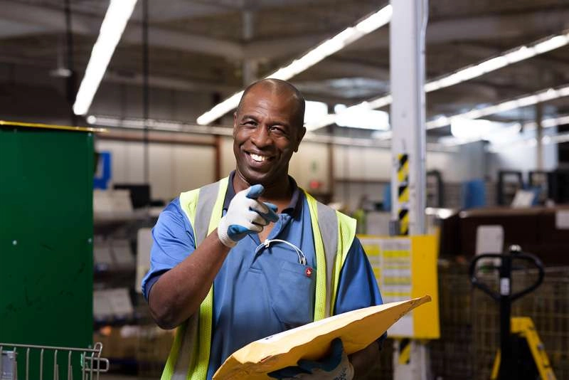 Mail carrier poses for photographer
