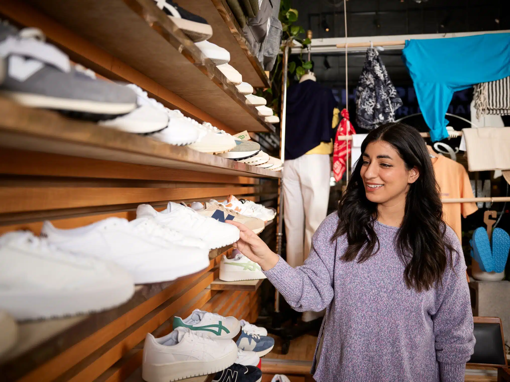 Retail store customer shopping for shoes.