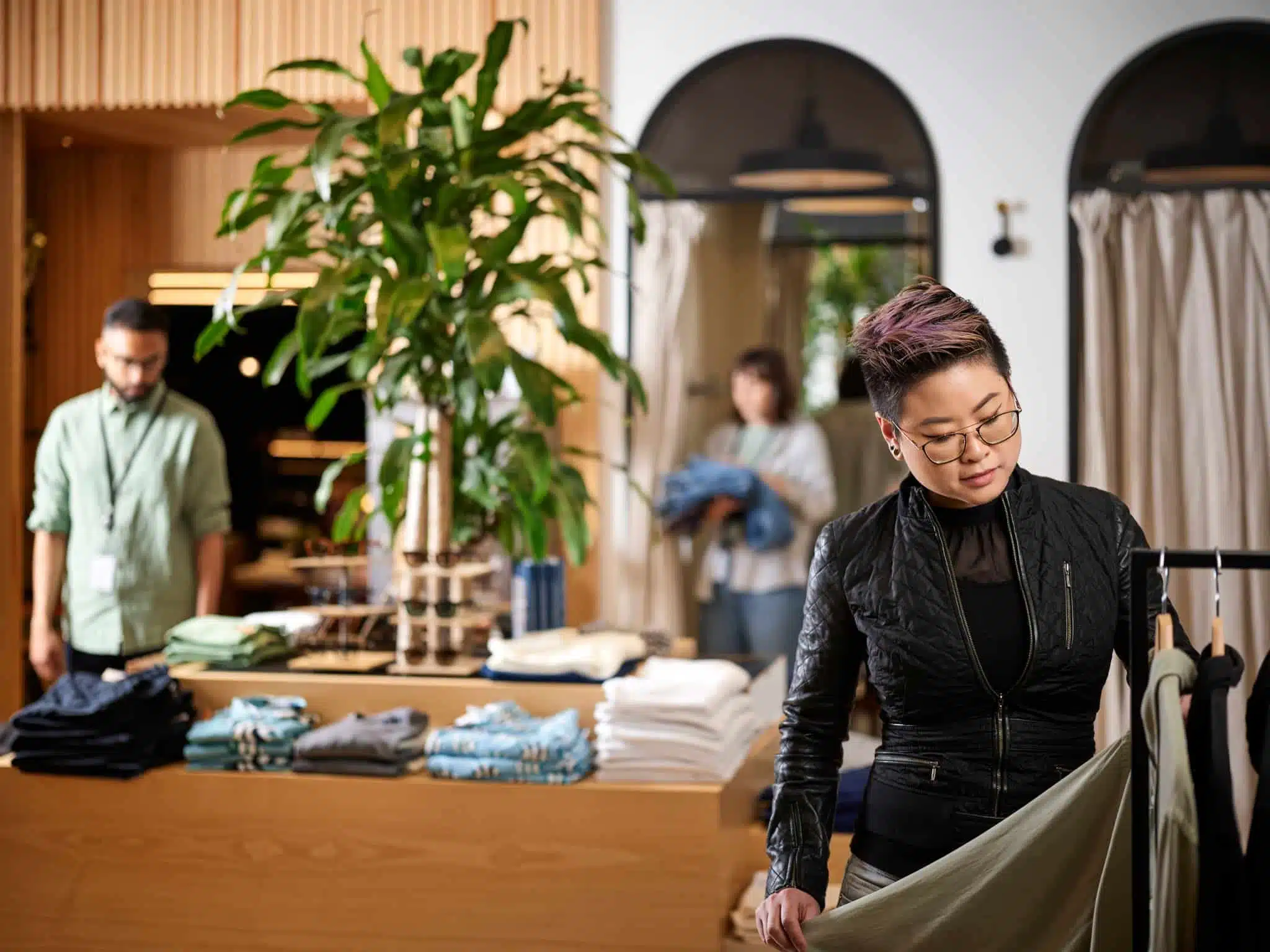 Retail store customer shopping with employees blurred in the background