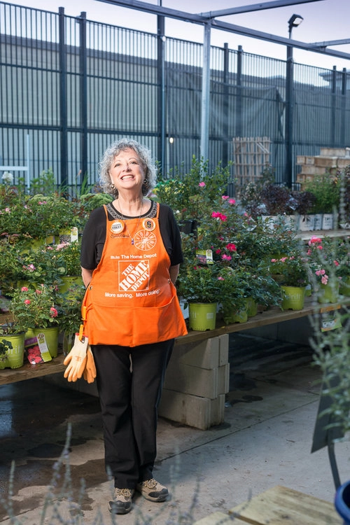 A creative editorial image of a home depot team member in the garden centre.