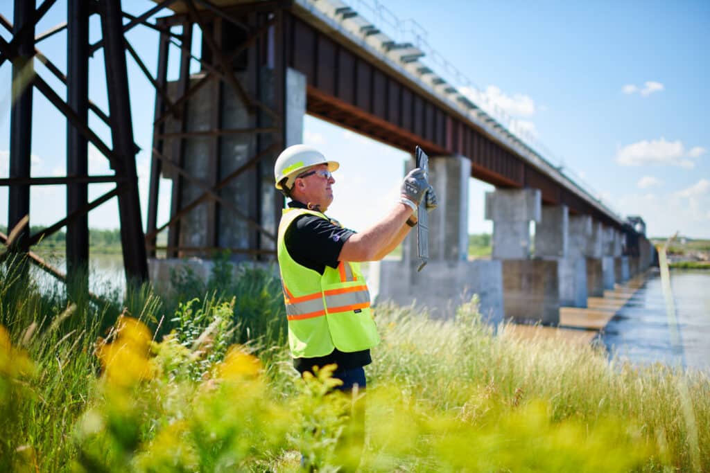 Construction worker uses tablet for images