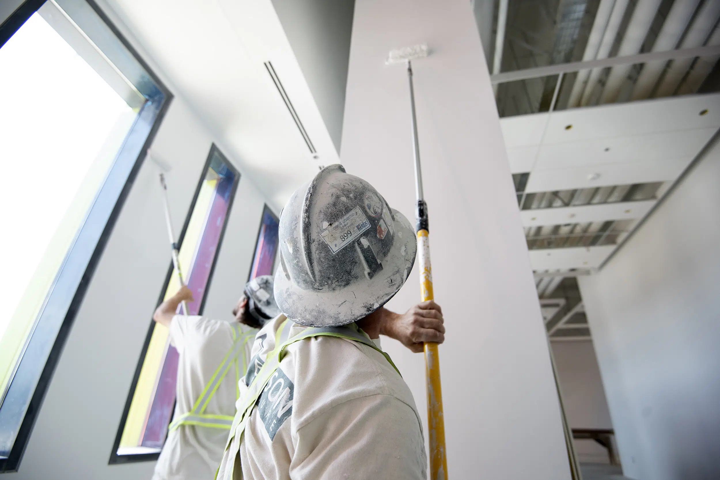 Industrial painters hard at work completing a large project.