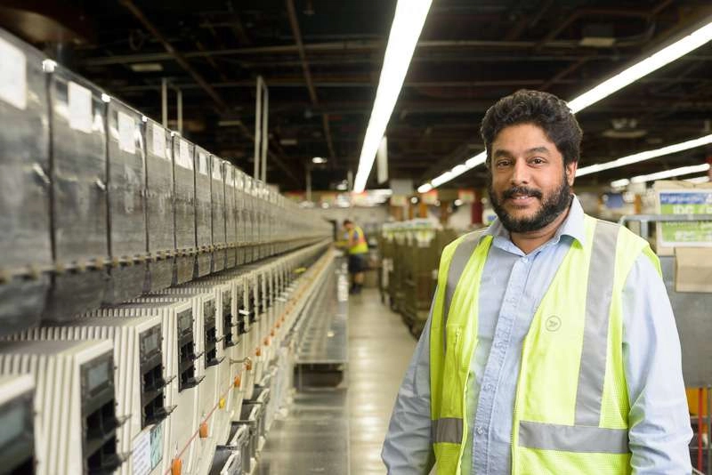 Worker in front large production line