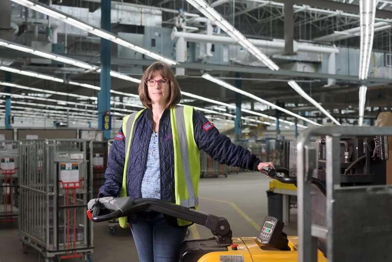 A warehouse employee operates a small forklift. Using the existing light in the factory i was able to create a very dramatic background for this image.