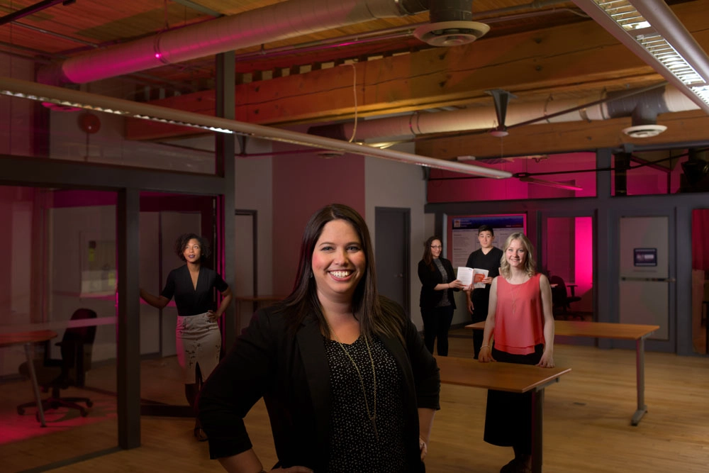 A group of young entrepreneurs pose for a group photo in an office