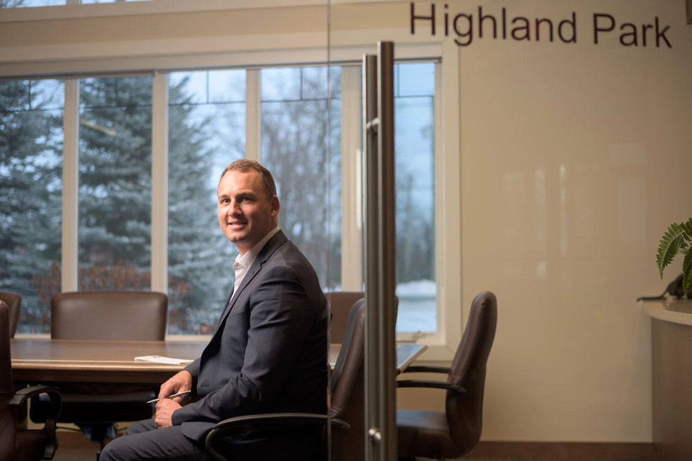 Business man sits at boardroom table