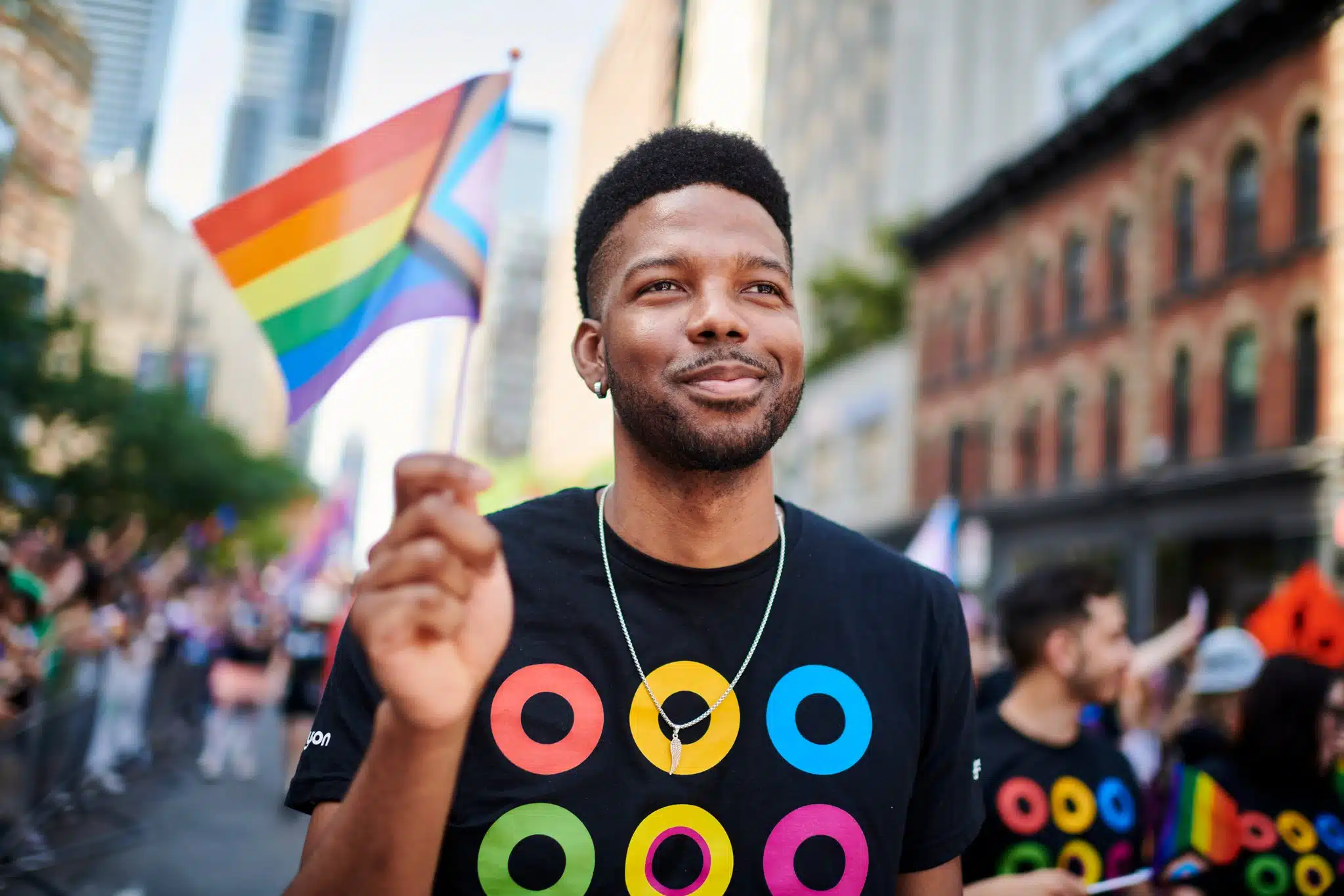 Storytelling image of employee marching at pride parade.