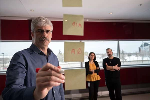 Photographing A Large Medical Research Facility - Dsc 6844Copy Man applies sticky notes in corporate planning session