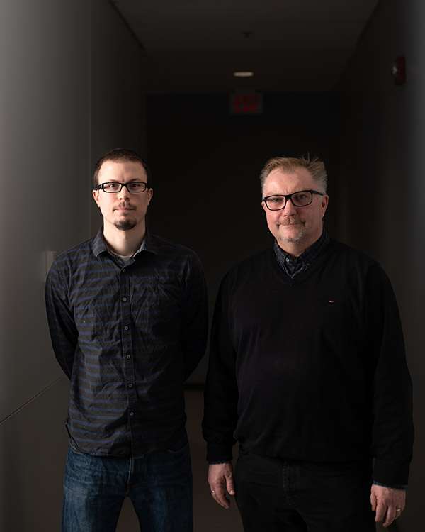 Photographing A Large Medical Research Facility - Dsc 7324Copy Two team members in a dark hallway