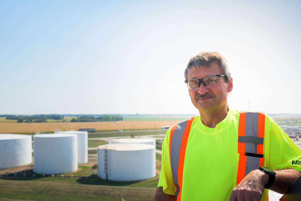 industrial worker on top of tank