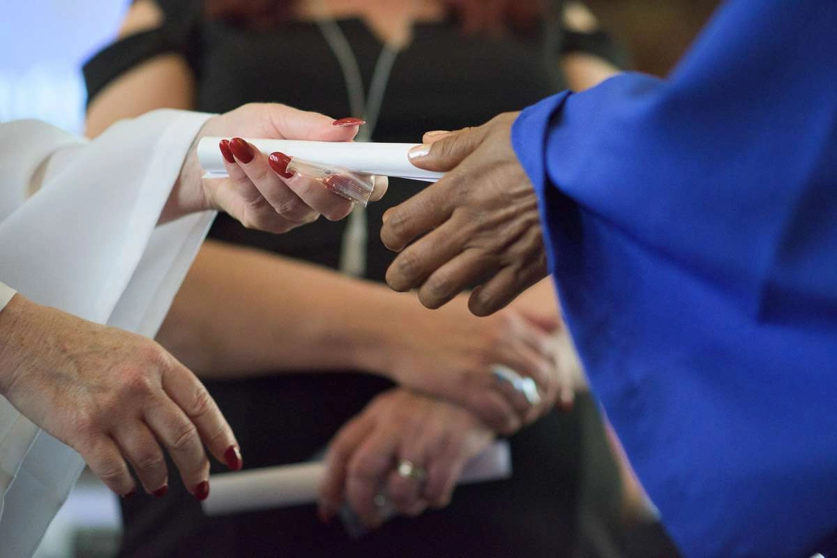 Editorial Photography For Cdi College - Editorial Photgrapher Robert Lowdon Cdi 15 An instructor hands a diploma to a graduate. This close-up shot focuses on their outstretched hands, highlighting the significance of this moment.