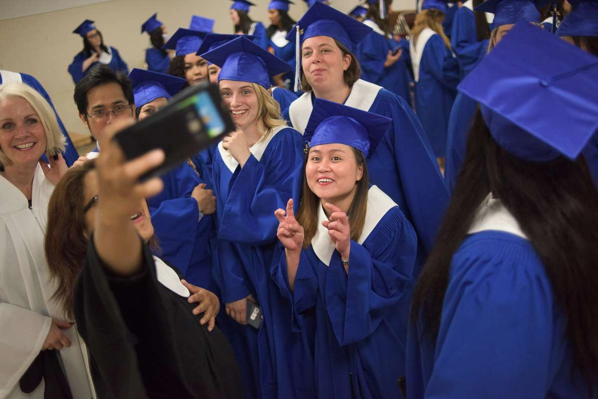 Editorial Photography For Cdi College - Editorial Photgrapher Robert Lowdon Cdi 3 There is a lot of activity in this photograph, which features a group of students and instructors taking a group shot using a phone. The photograph conveys the celebratory atmosphere of the event.