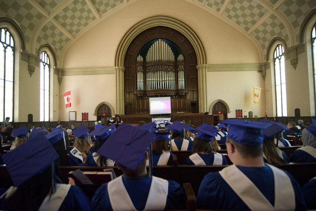 Editorial Photography For Cdi College - Editorial Photgrapher Robert Lowdon Cdi 8 This photograph captures the rows of seated students and the area above them reaching up to the high vaulted ceiling. This perspective emphasizes the architectural features of the space, and provides a sense of its size and the number of people in t…