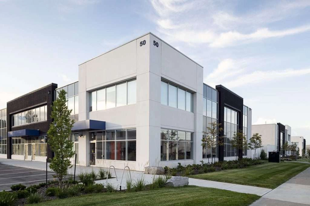 The image is of a group of industrial offices. The offices are all very clean and have modern designs. The desks are all neatly organized and there are few decorations.