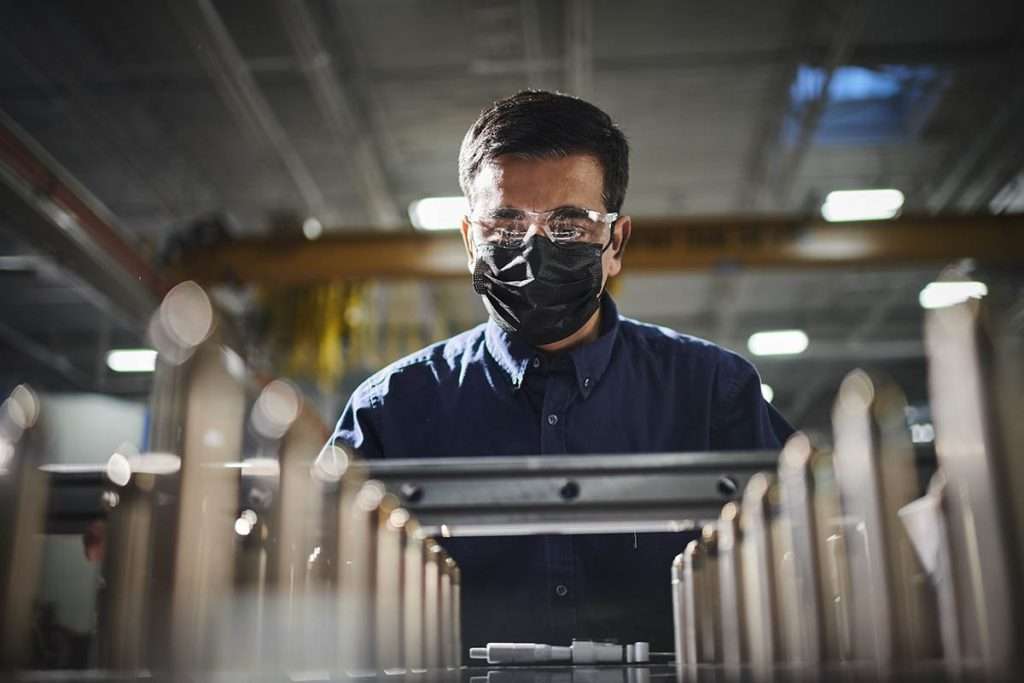 worker tightens bolts