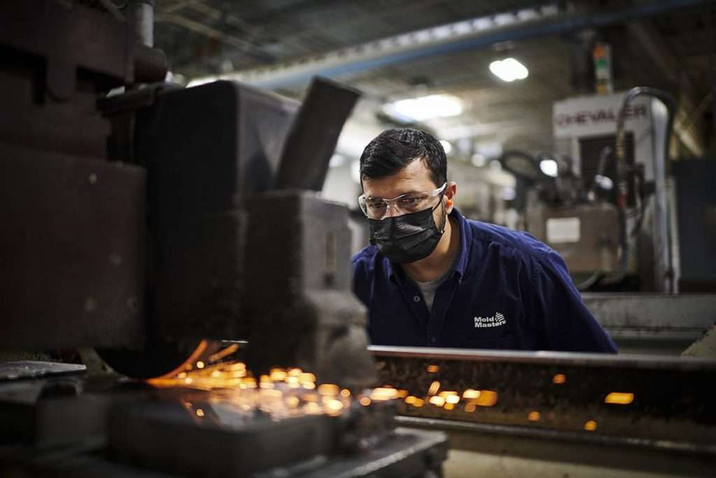 worker inspect machine grinding