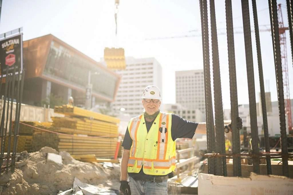 Construction forrman with crane in background