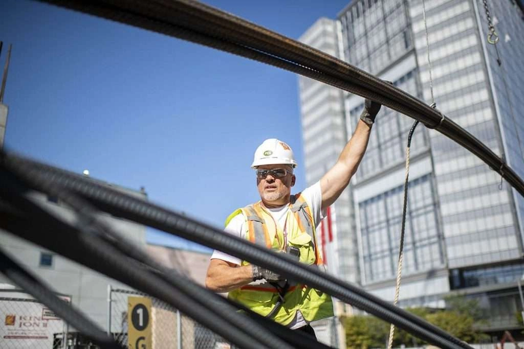 Worker inspects re bar on truck