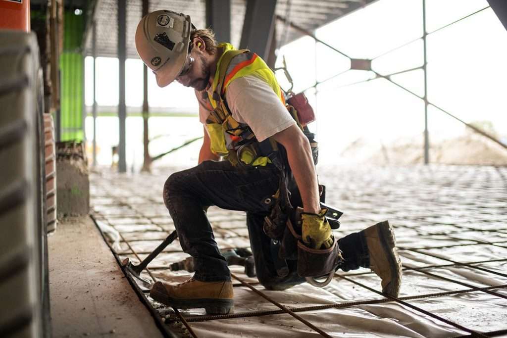 Construction worker ties rebar