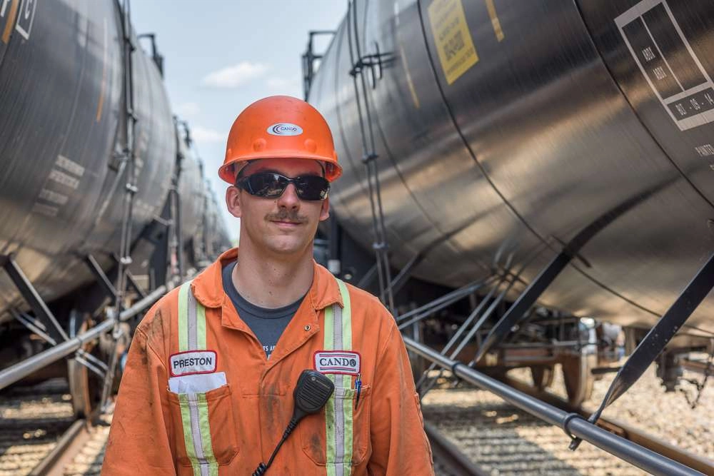 Rail worker in between cars