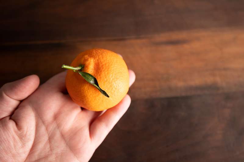 Stock Photography: Story Of An Orange - Orange 2 Holding the orange over a board