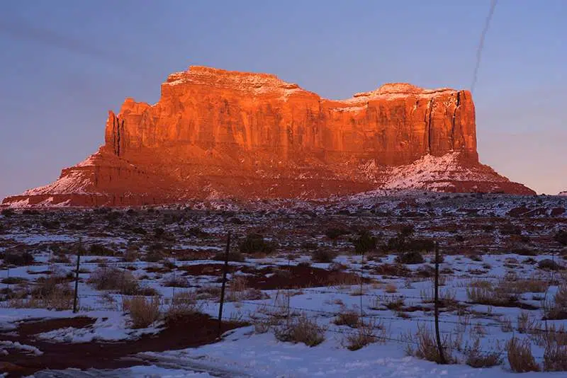 Golden sunlight washes across a butte in colorado