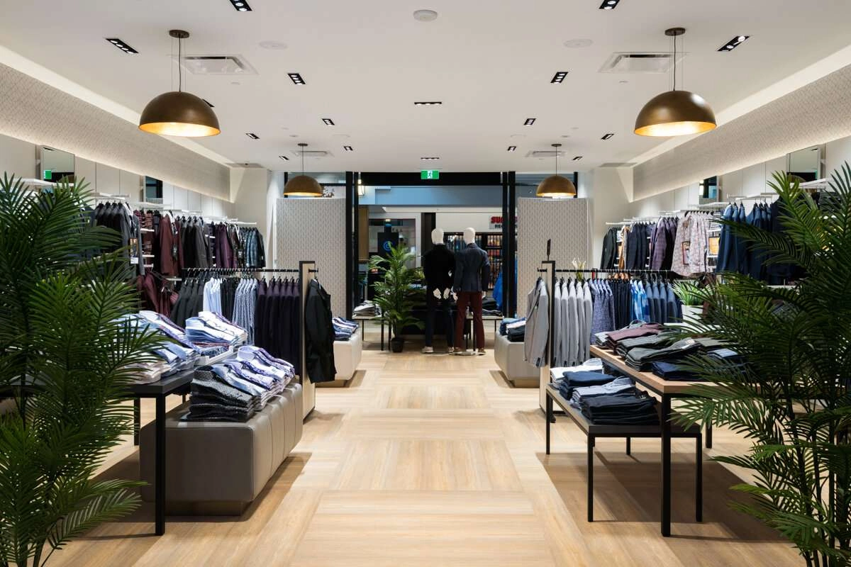 Plants in foreground of shop.