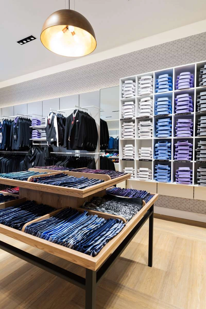 Tie display with shirts in back.