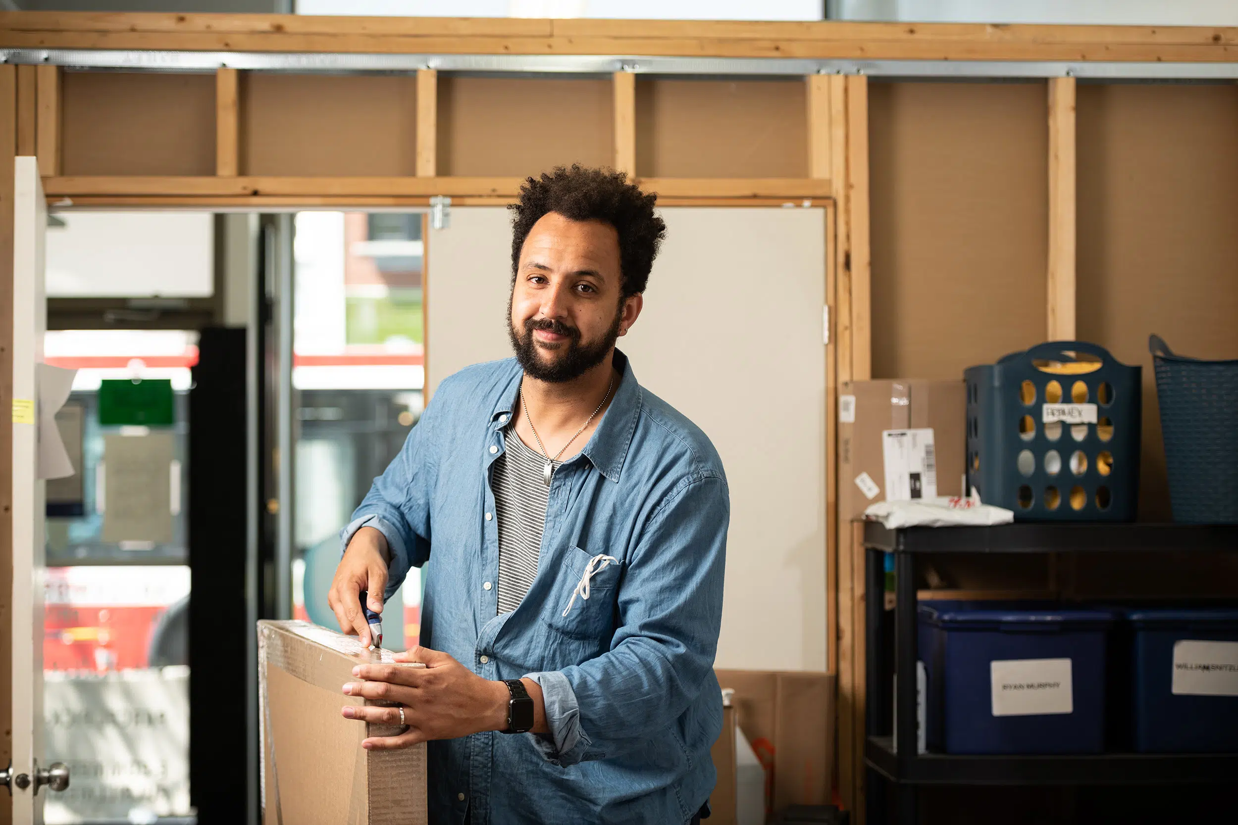 Image of worker opening box