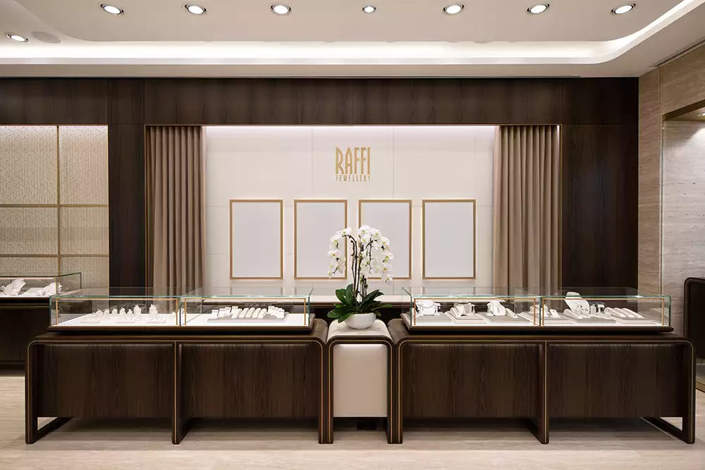 This photograph was taken inside a retail store. The layout of the store is clearly visible, with merchandise displayed on the shelves and in the cases.  